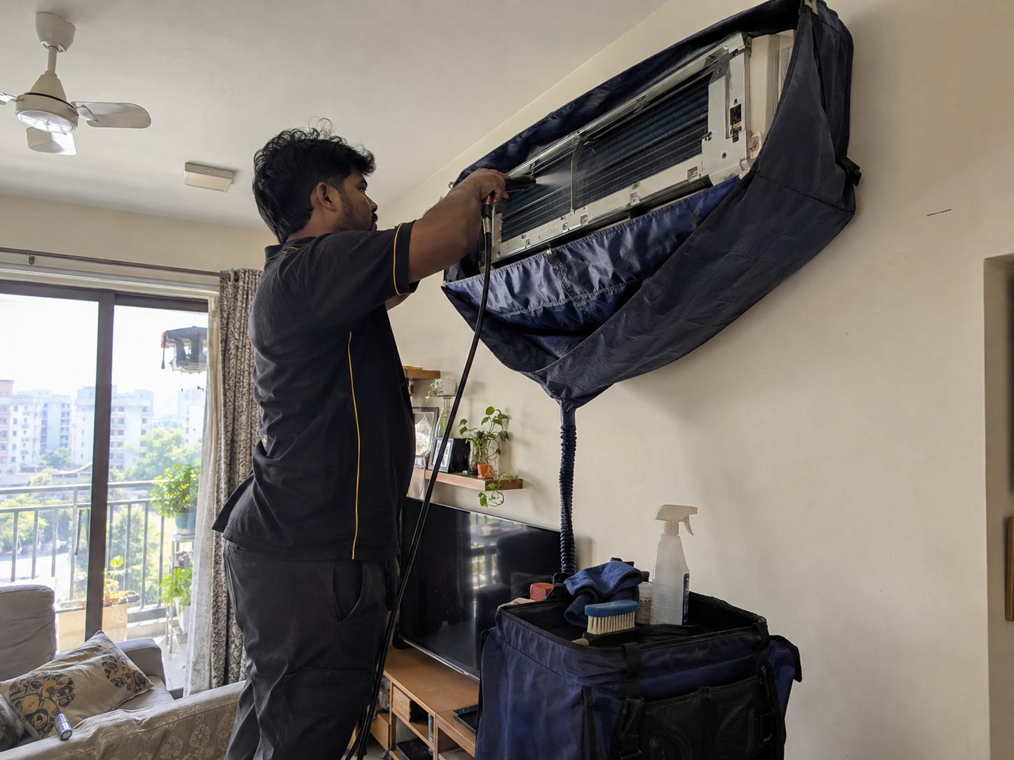 Technician servicing a wall-mounted air conditioner