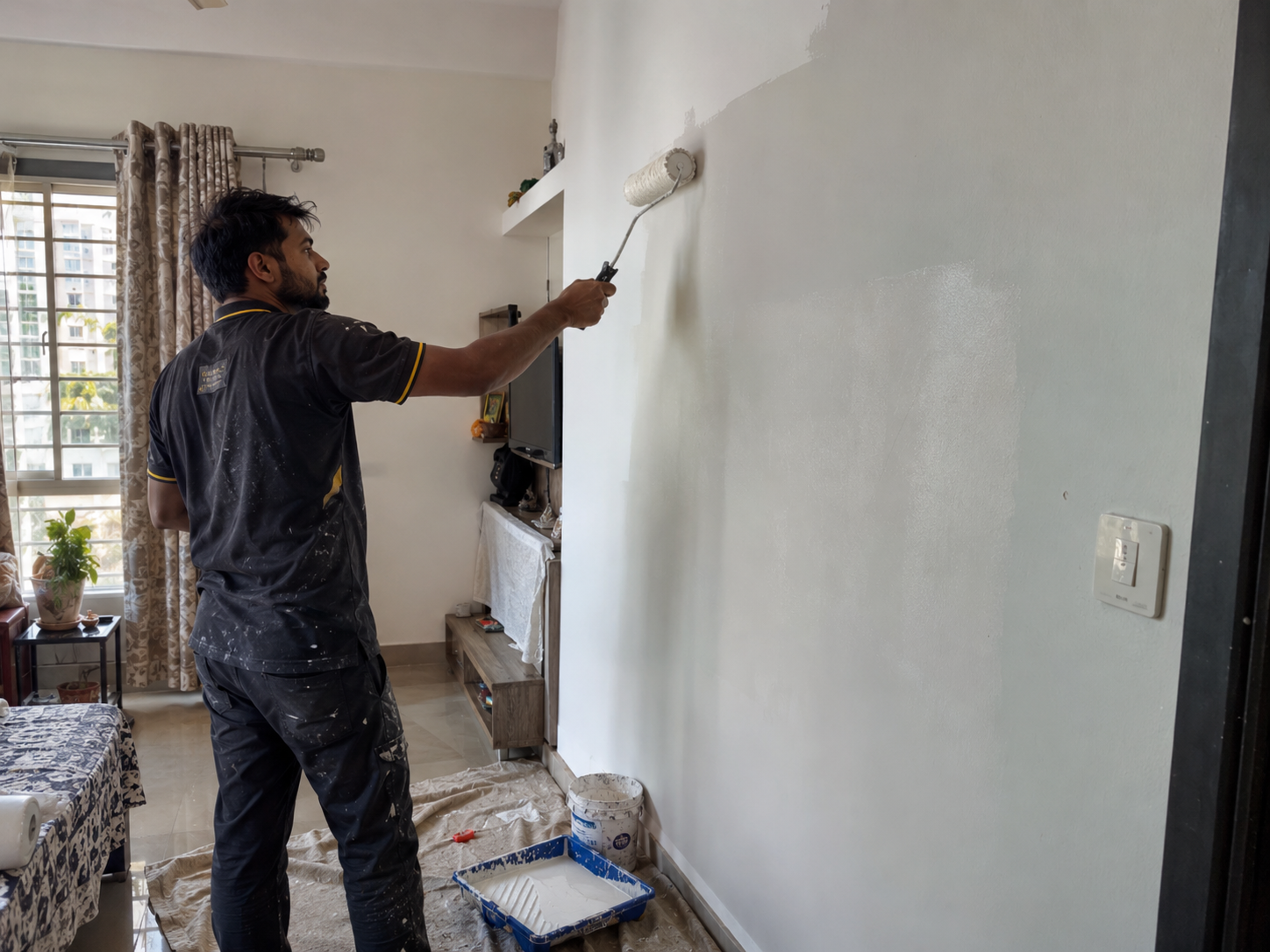 Painter applying a fresh coat to an interior wall